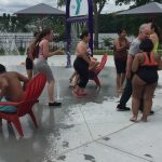 Group of people playing outside at a fountain park
