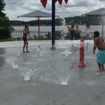 Kids playing at a fountain park