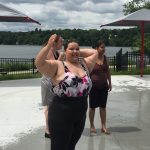 Group of people playing outside at a fountain park