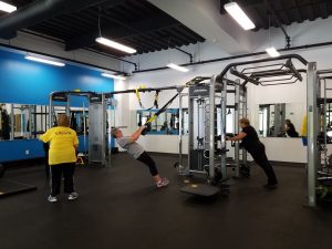 A group of individuals exercising in a gym during the LIVESTRONG event in Central Massachusetts