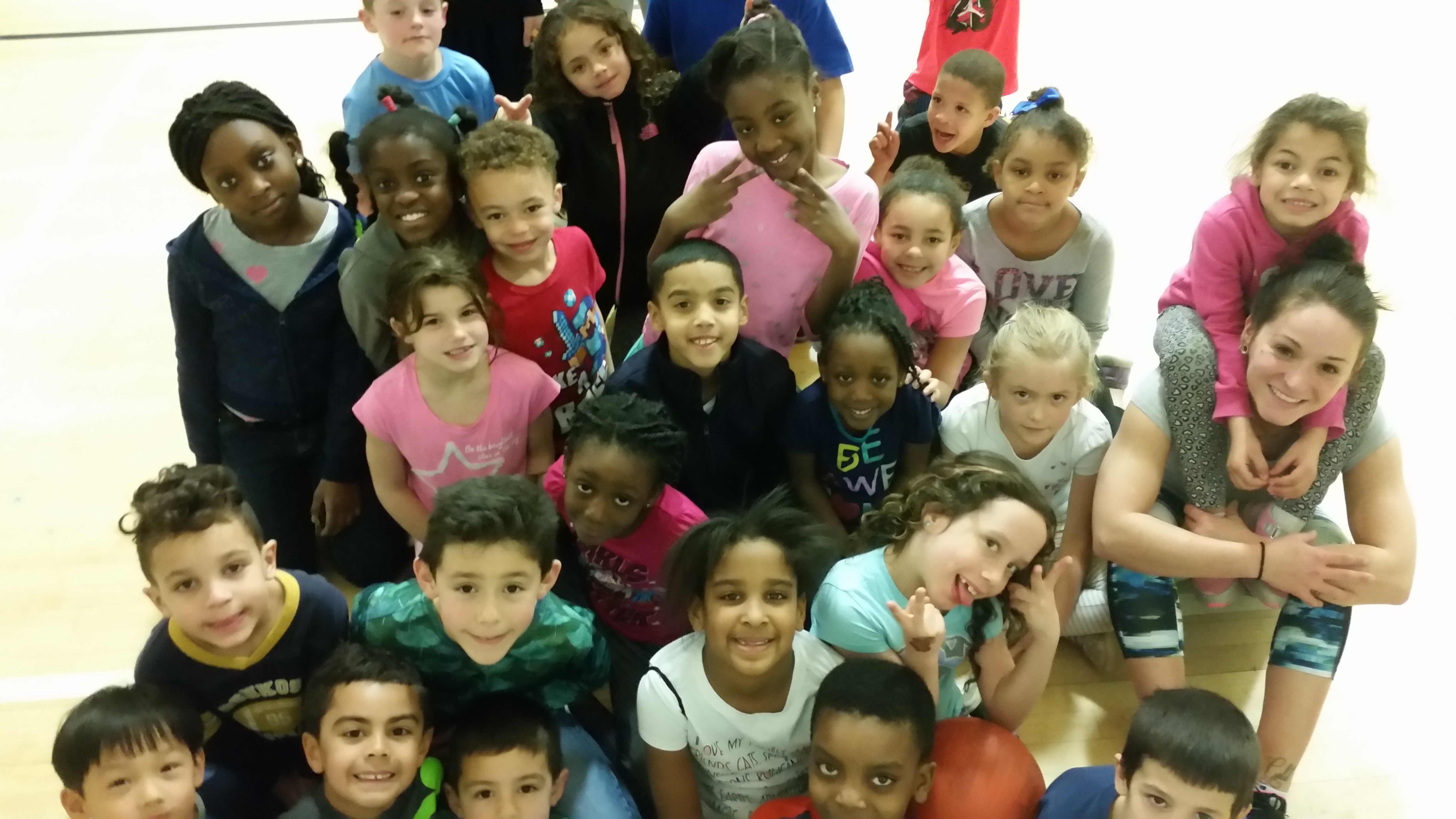 A group of students posing for a picture during their summer camp near Indian Lake in Worcester, MA
