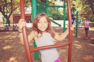 A young girl playing in the playground