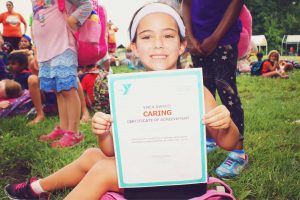 A young girl won a certificate from the YMCA in Central Massachusetts