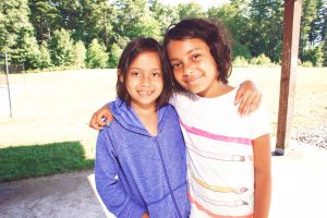 Two girls posing for a picture during summer camp in Lancaster, MA