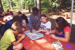 A group of young girls playing in a garden during her summer camp in Worcester, MA