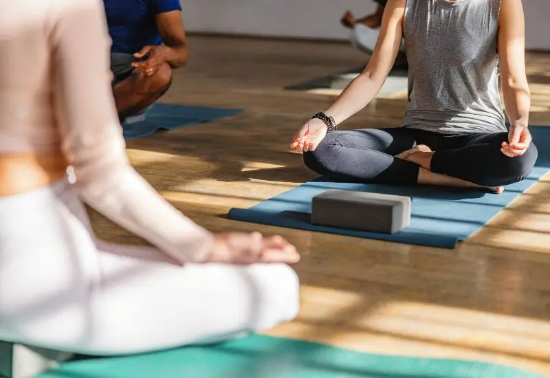 Diverse students taking a yoga class in studio