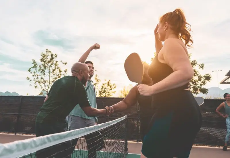 Group of people finishing up a match of pickleball