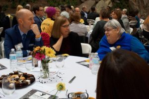 Attendees enjoying a meal together at a table during the LIVESTRONG event in Central Massachusetts.