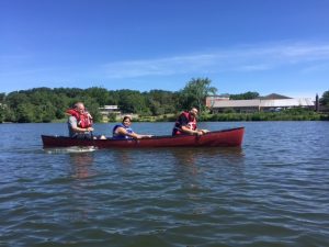 Three people gliding across a lake, part of an exercise session in Central Massachusetts.