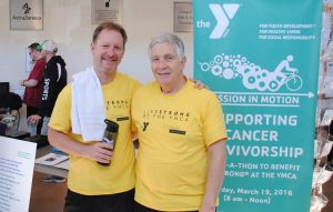 Two men in yellow shirts stand side by side at a LIVESTRONG event in Central Massachusetts.