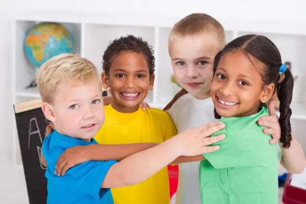 Four children in a group hug in Central Massachusetts