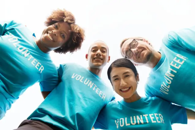 Four volunteers wearing blue t-shirts in Central Massachusetts
