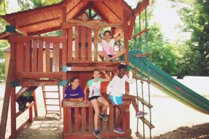 A group of kids playing at a playground in Central Massachusetts