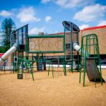New Playground for TriCommunity featuring a slide and swings in Central Massachusetts