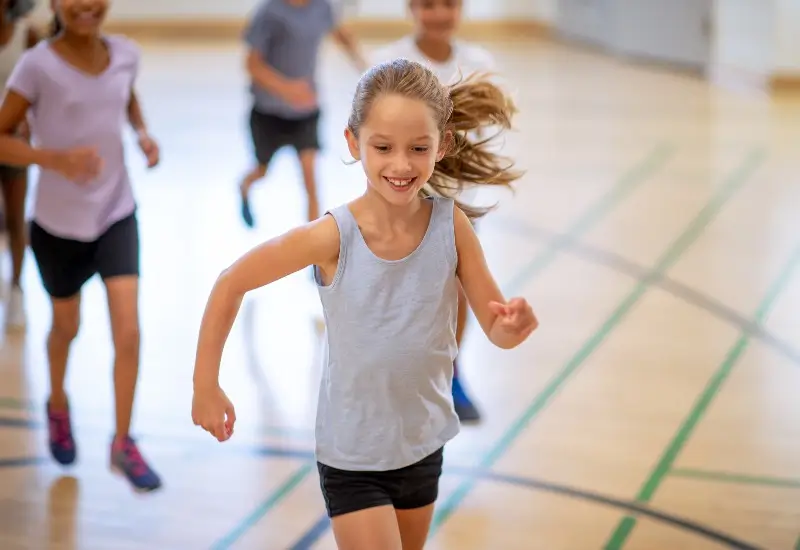 Elementary aged kids running in gym