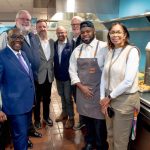 Group standing together inside the YMCA of Central Massachusetts kitchen space