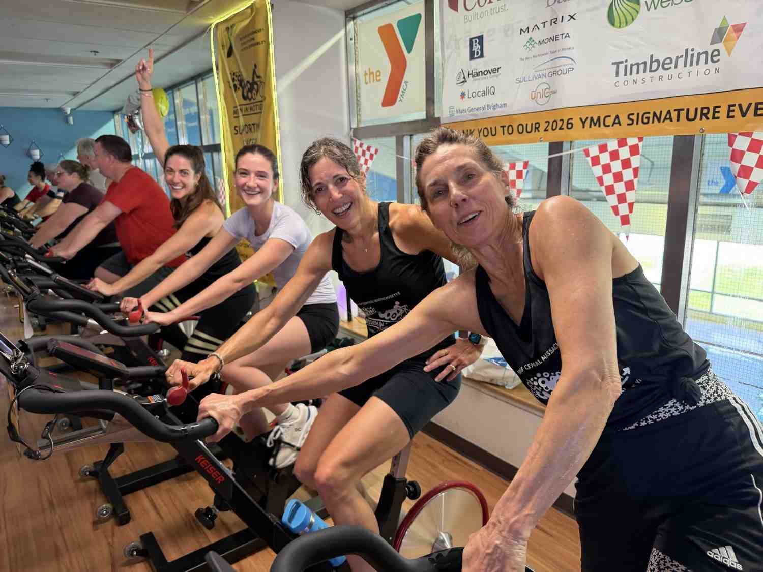 Participants cycling indoors during the YMCA Mission in Motion fundraiser event
