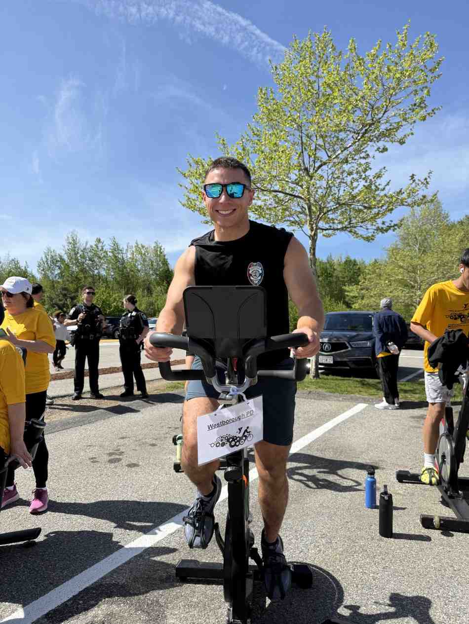 Participant riding a stationary bike at the YMCA Mission in Motion outdoor cycling fundraiser event