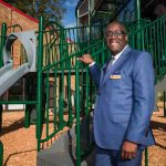 Representative standing at the newly completed TriCommunity YMCA playground