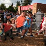 Children entering the new TriCommunity YMCA playground after the ribbon cutting